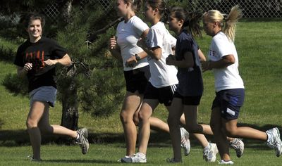 Post Falls senior Angie Whalen, left, chats with teammates during practice.  (Kathy Plonka / The Spokesman-Review)