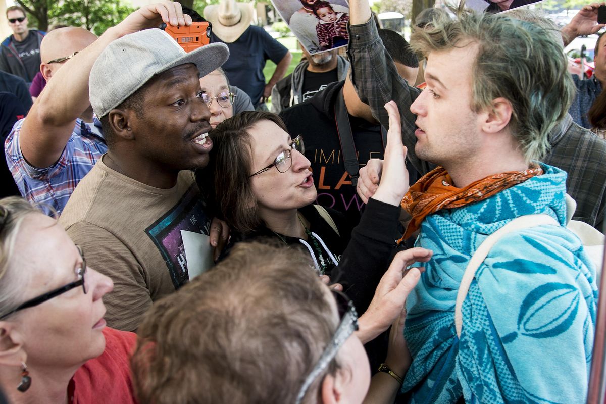 A protester, on right, tries to disrupt the Black Lives Matter rally in front of the Spokane County Courthouse, Saturday, July 9, 2016. (Colin Mulvany / The Spokesman-Review)