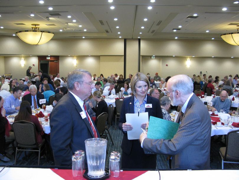 Candidates Lawerence Denney, left, and Holli Woodings, center, confer with moderator Jim Weatherby, right, before the City Club of Boise debate on Monday (Betsy Russell)