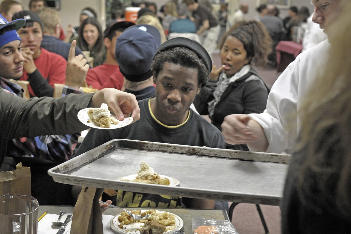 Je’Don Vaughn eyes the pie as he works his way through a Thanksgiving feast cooked up by culinary program students at Spokane Skills Center on Tuesday. The students prepared and served a meal for students, staff and family of the Skills Center and On-Track Academy. (Christopher Anderson)