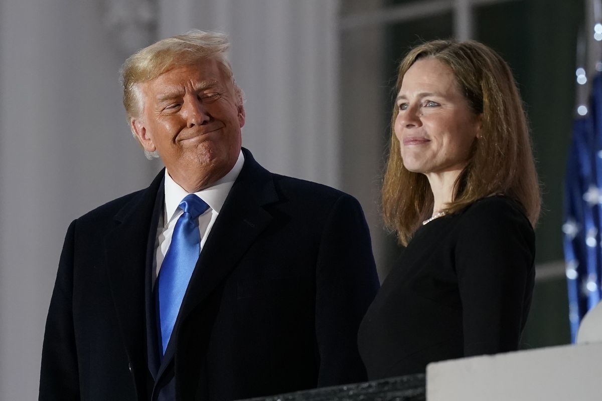 President Donald Trump and Amy Coney Barrett stand on the Blue Room Balcony on Oct. 26 after Supreme Court Justice Clarence Thomas administered the Constitutional Oath to her on the South Lawn of the White House White House in Washington. (Patrick Semansky)