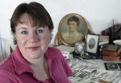 
Miriam Midkiff collects her families' memories and artifacts, including a picture of adoptive great-grandmother Nellie Concidine Holst from 1905, shown in background.
 (The Spokesman-Review)