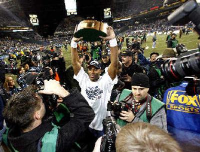 
Seattle Seahawks Shaun Alexander holds up the NFC Championship trophy. 
 (Associated Press / The Spokesman-Review)