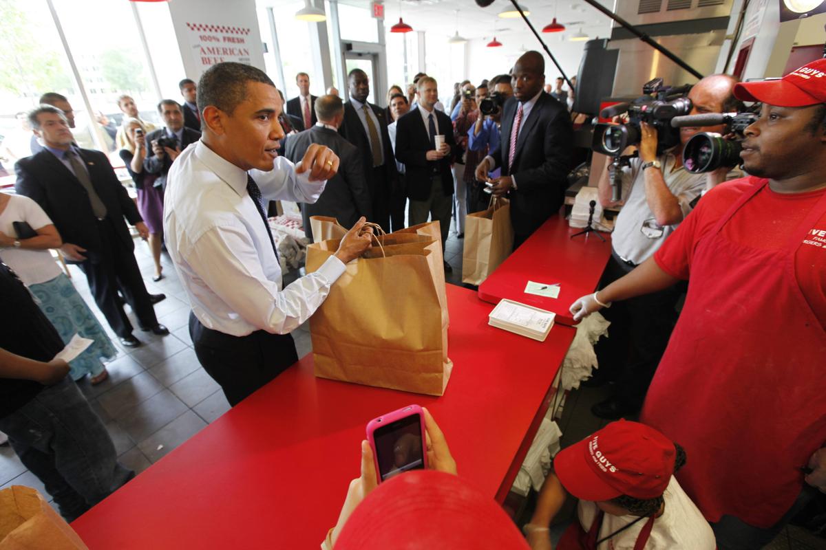 President Barack Obama orders a hamburger at the Five Guys Burgers and Fries in Washington, D.C., in 2009. Five Guys, which specializes in double-pattied behemoths, was the fastest-growing restaurant chain in America last year. (Associated Press)