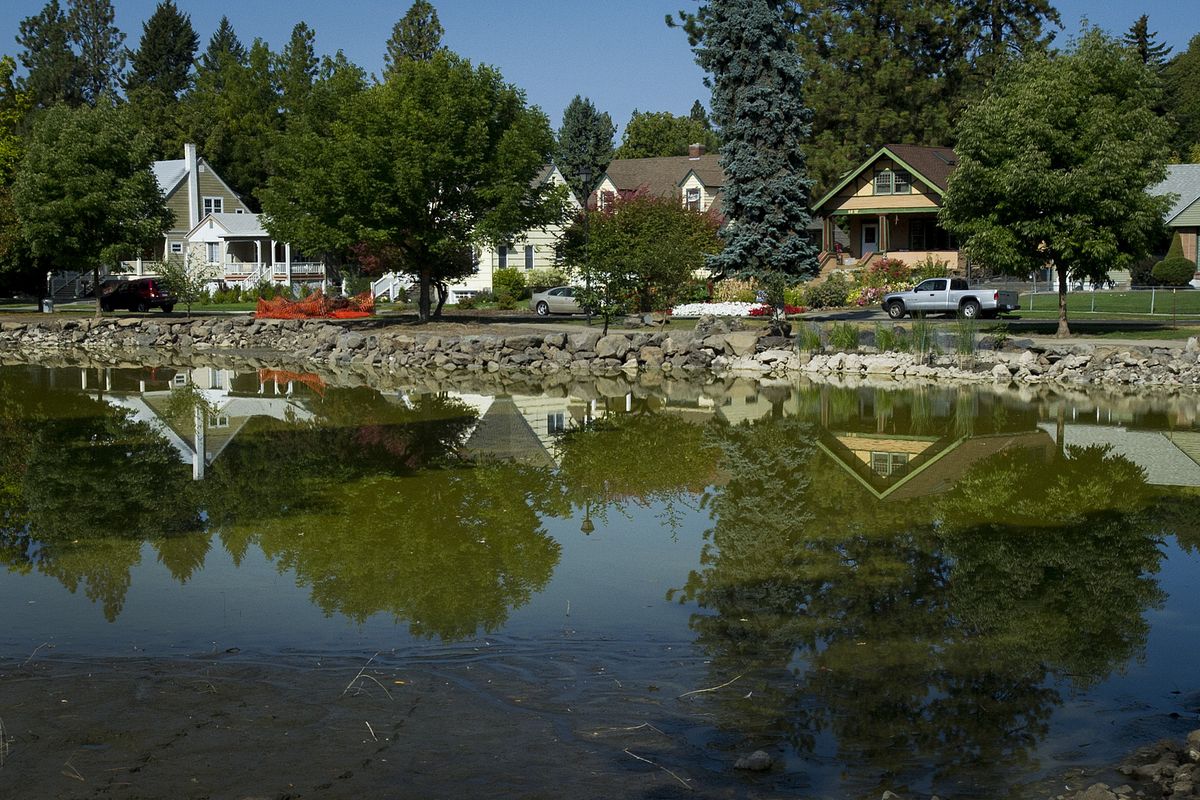 The water level of Mirror Pond in Manito Park has been lowered so the shoreline can be lined with basalt boulders.