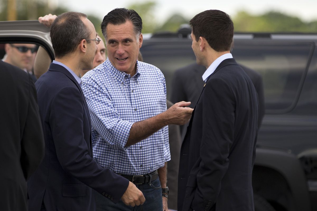 Republican presidential candidate, former Massachusetts Gov. Mitt Romney, center, talks with foreign policy adviser Dan Senor, left, and his vice presidential running mate, Rep. Paul Ryan, R-Wis., before boarding his campaign plane at Daytona International Airport, Saturday, Oct. 20, 2012, in Daytona Beach, Fla. (Evan Vucci / Associated Press)