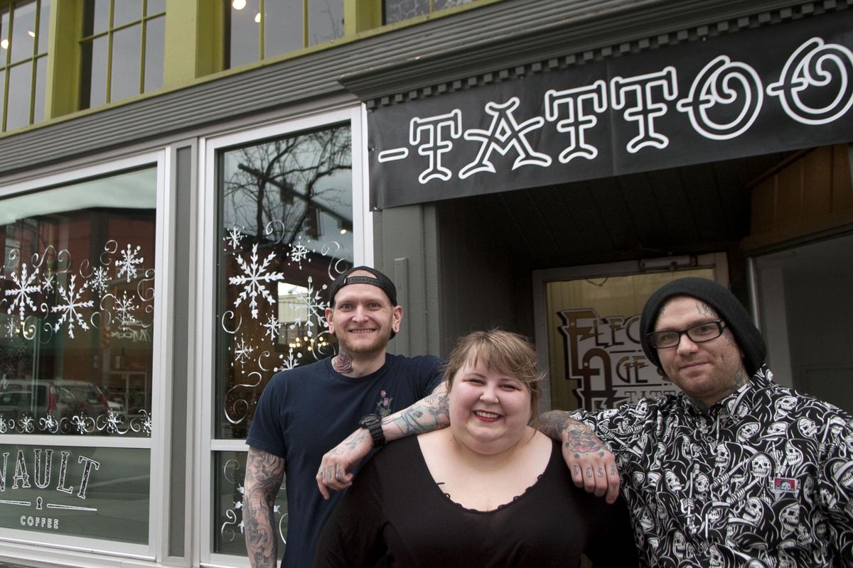 Tattoo artists Jayme Goodson, Christina Villagomez and Jake Sifford of the Electric Age Tattoo in Coeur d’Alene are photographed before their tattoo charity drive for the Children’s Village on Friday. Villagomez and Sifford co-own Electric Age. (Kathy Plonka / The Spokesman-Review)