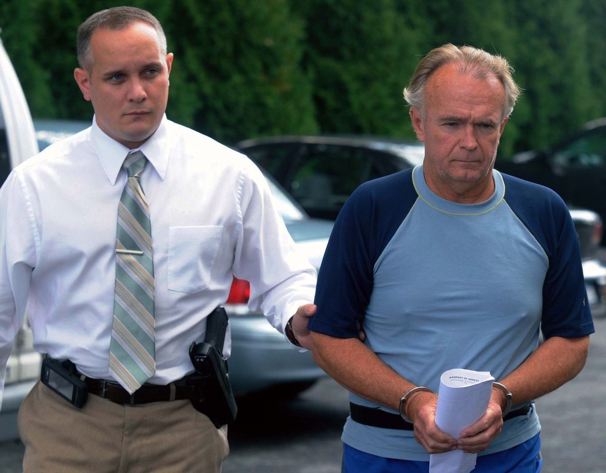 In this Monday, Sept. 13, 2012 photo, The Rev. Arthur Burton Schirmer, 62, right, is led into district court by Pennsylvania State Trooper Bill Skotleski in Tannersville, Pa.  Schirmer is accused of killing his wife and staging a car accident in July 2008 to cover up the murder. On Friday, Sept. 28, 2012 he was charged in the death of his first wife, Jewel, in 1999. (David Kidwell / Pocono Record)