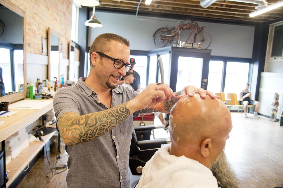 Barber Chris Banka puts a  tight shave on the scalp of customer Bill Breckon at Brickyard barbershop Wednesday, June 8 , 2016, at 2802 N. Monroe St. (Jesse Tinsley / The Spokesman-Review)