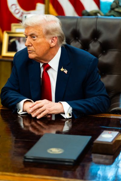 President Donald Trump speaks with the press in the Oval Office on Thursday.   (Demetrius Freeman/The Washington Post)