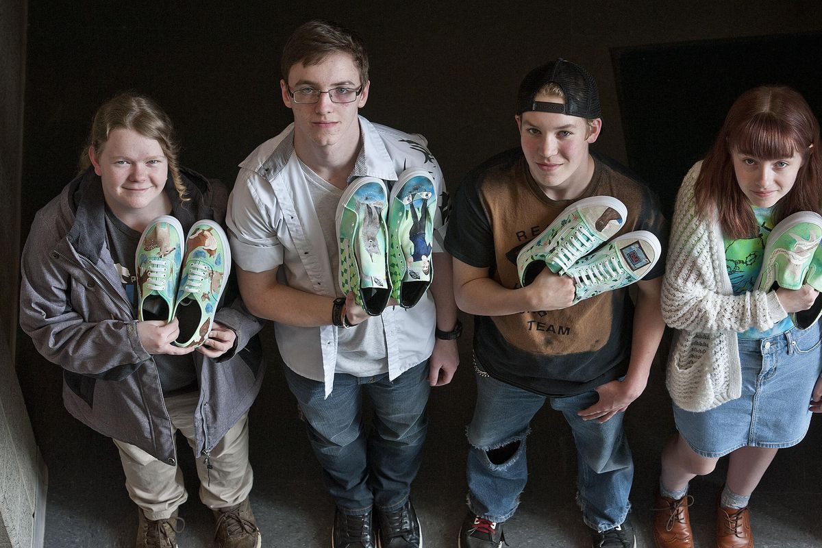 Students from Central Valley High School, from left, Cassidy Kippenhan, junior, Peter Cleary, junior, Ezekiel Gehr, freshman and Jaiden Haley, junior, show of a few of their designs for Vans shoes at the school on Wednesday, April 26, 2017. Vans announced the Top 50 high schools in the Vans Custom Culture art competition, and Central Valley High School has advanced to the semi-finals. (Kathy Plonka / The Spokesman-Review)