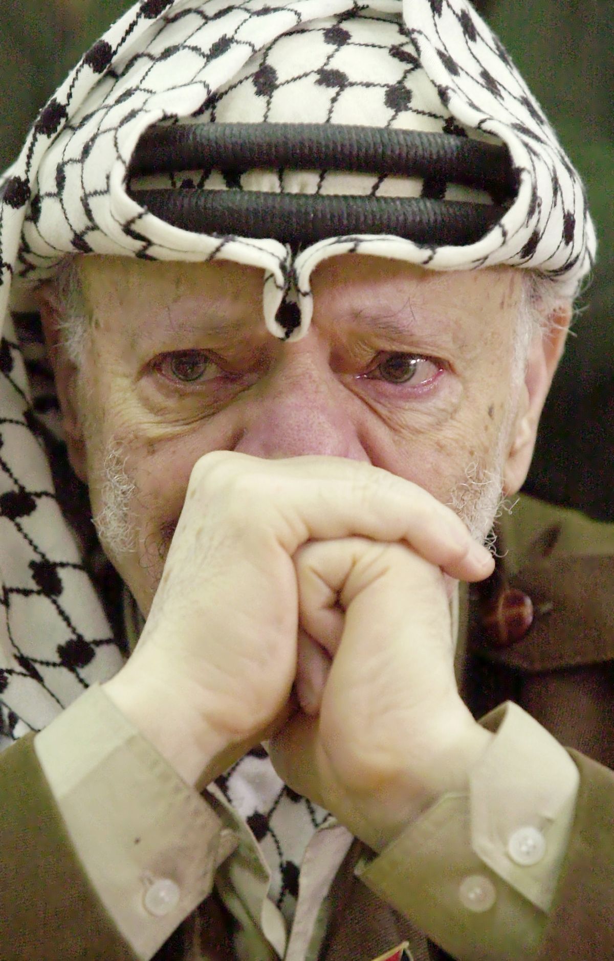 FILE - In this Aug. 13, 2003 file photo, Palestinian leader Yasser Arafat, with tears in his eyes, after he was informed of the death of his sister Yousra Abdel Raouf Al Kidwah at his compound in the West Bank town of Ramallah. French prosecutors opened a murder inquiry into the death of Yasser Arafat on Tuesday, Aug. 28, 2012, judicial officials told a French new agency, after his widow and a TV investigation raised new questions about whether the Palestinian leader was poisoned. (Nasser Nasser / Associated Press)