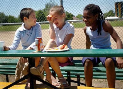 
Alex Mertinez, 10, Rebekah Hyatt, 9,  and Larrianna Chenevert, 10, eat lunch Friday after competing in a kickball tournament. 
 (Amanda Smith / The Spokesman-Review)