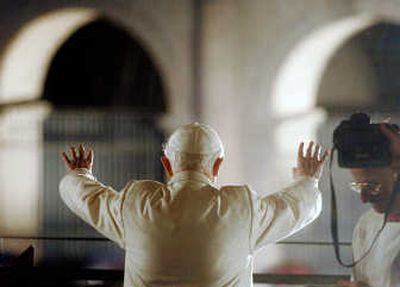 
Pope Benedict XVI waves to the faithful at the end of the Way of the Cross procession at the  Colosseum in Rome on Friday. Associated Press
 (Associated Press / The Spokesman-Review)