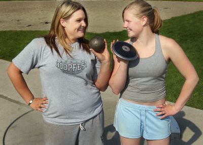 
Lyndzie Johnson,  left, and Kenzie Carter,  who  throw the shot put and discus for East Valley High School, hang out after track practice.
 (Kathryn Stevens / The Spokesman-Review)