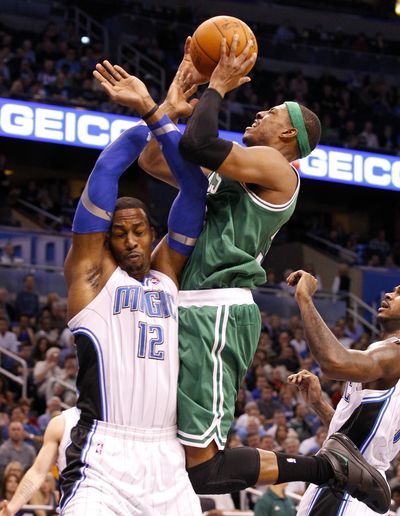 Paul Pierce of the Boston Celtics draws a foul on the Orlando Magic’s Dwight Howard during the first half Thursday. (Associated Press)