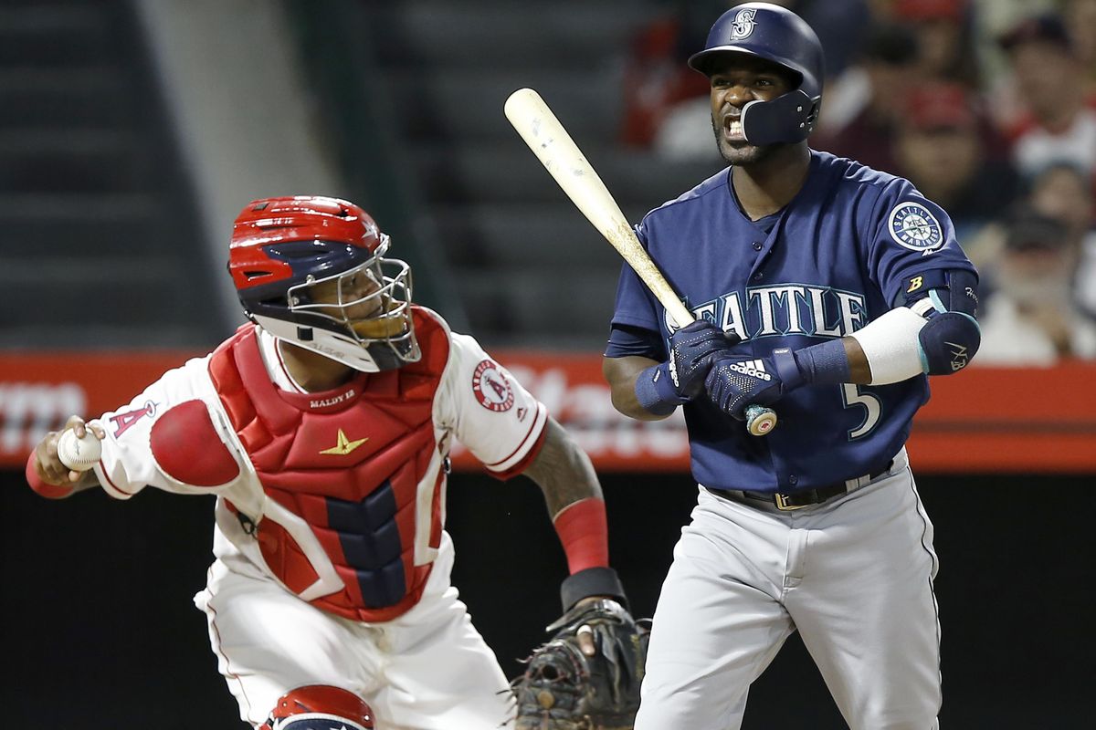 Seattle’s Guillermo Heredia reacts after being called out on strikes, as Los Angeles Angels catcher Martin Maldonado prepares to throw the ball during the fourth inning Tuesday. (Alex Gallardo / AP)