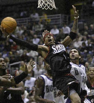 
Philadelphia 76ers' Allen Iverson, front, shoots in front of Milwaukee's Dan Gadzuric, right, Tuesday night.
 (Associated Press / The Spokesman-Review)