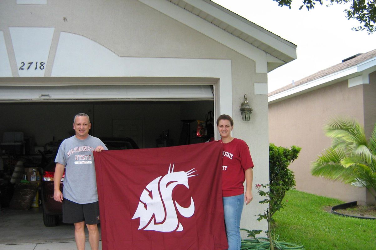 Fans from around the country, including Will and Stefanie Walker, have waved the Washington State flag, Ol