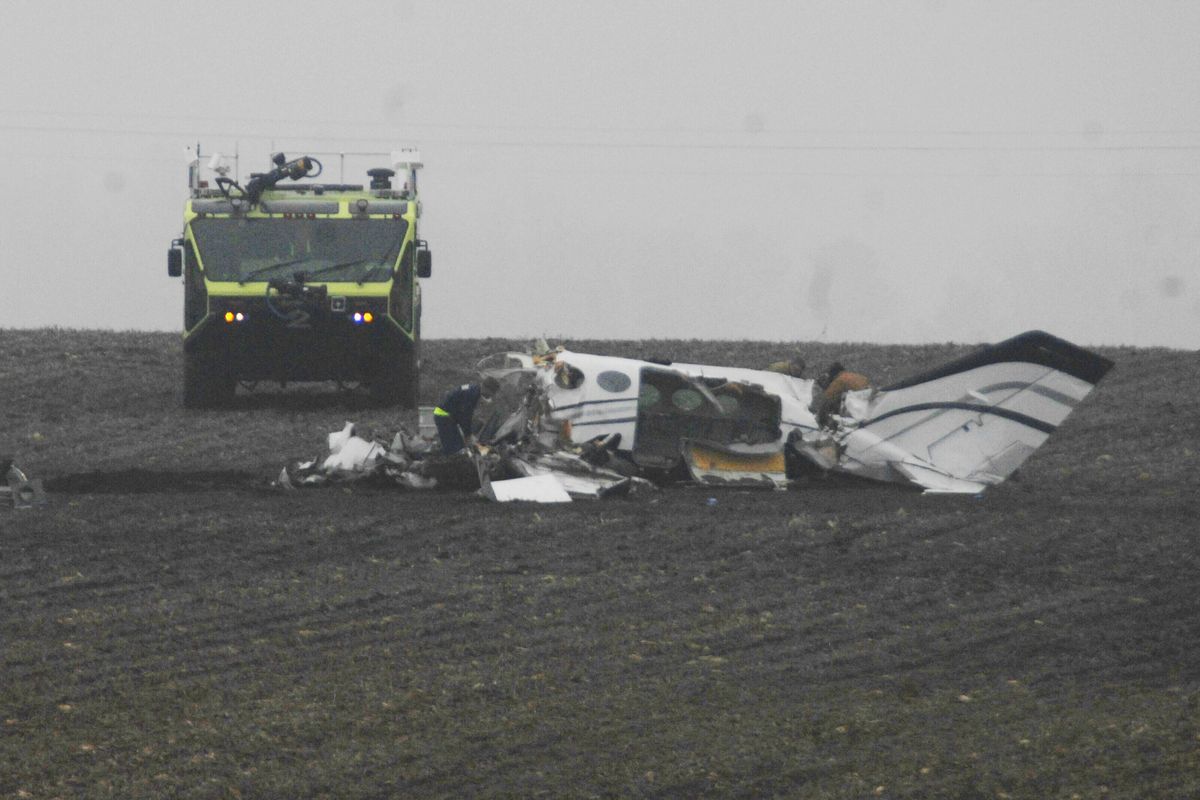 Investigators work at the site of a small plane crash Tuesday near Bloomington, Ill., that claimed the lives of seven people, including Aaron Leetch. (Associated Press)