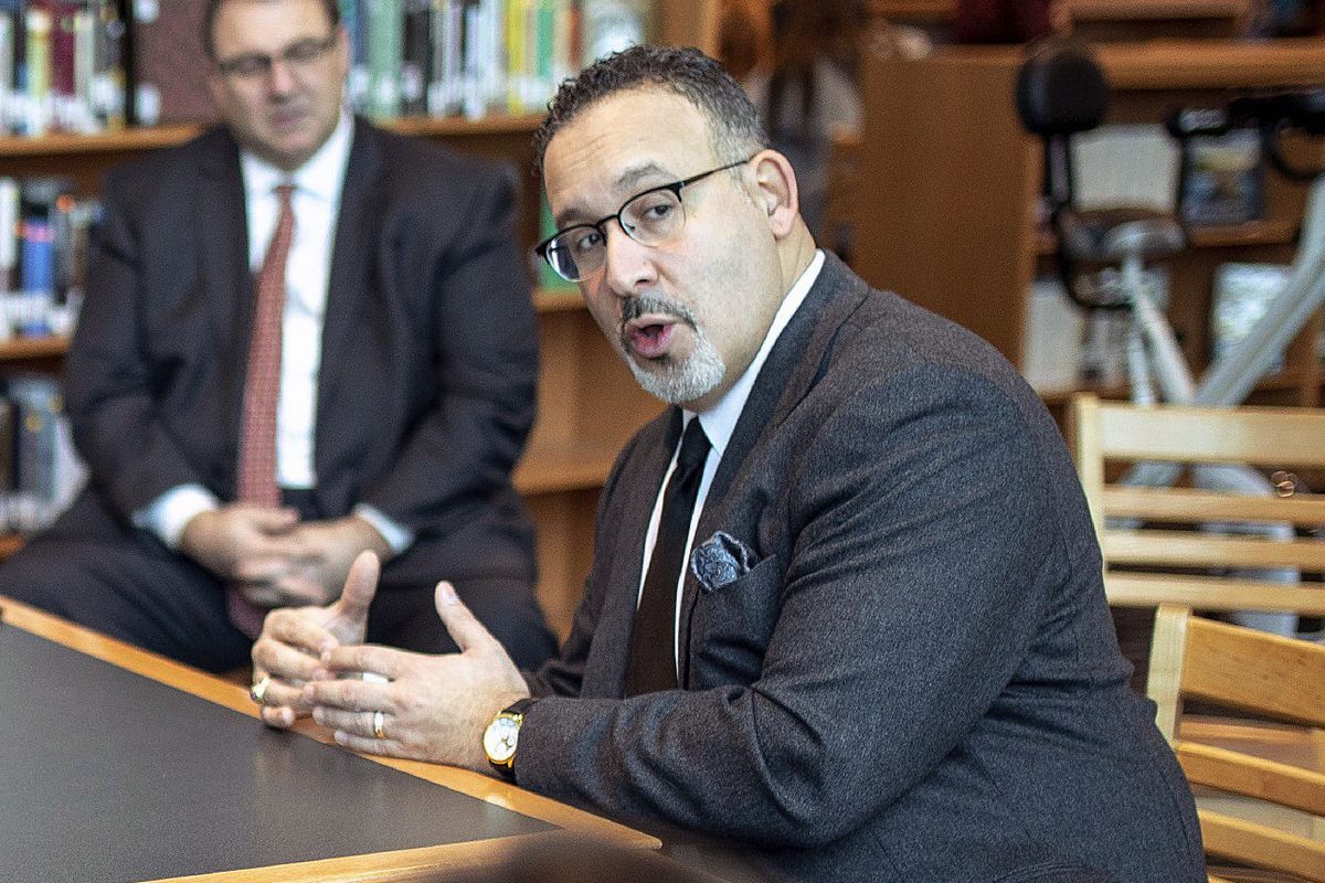 FILE – In this Jan. 28, 2020 file photo, Connecticut State Commissioner of Education Miguel Cardona speaks with Berlin High School students while on a tour of the school. President-elect Joe Biden has chosen the education commissioner for Connecticut and a former public school teacher to serve as education secretary.  (Devin Leith-Yessian)