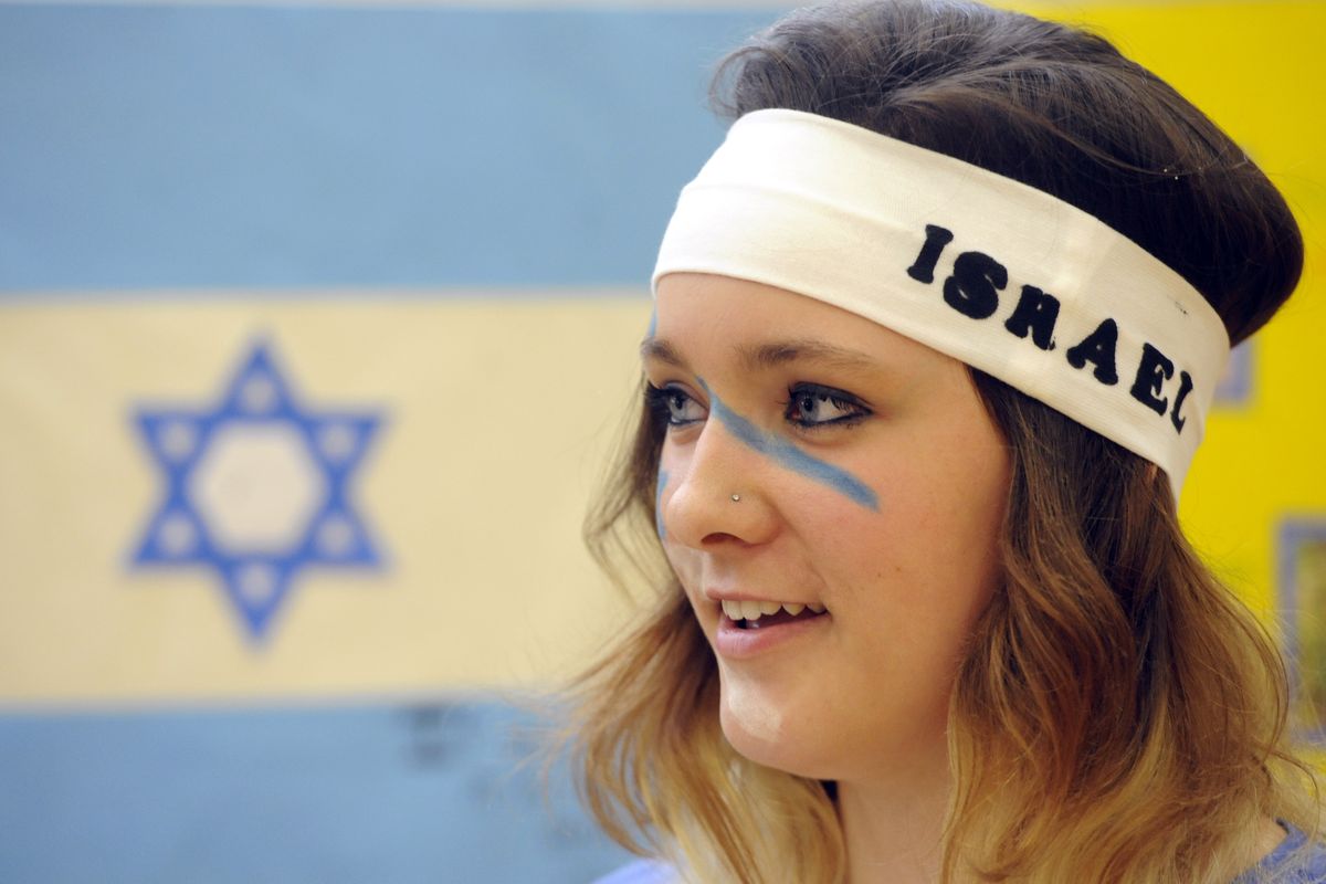 Andrea Gasser, a Central Valley High School junior, represents Israel at the International Economic Summit on Tuesday at the school. Students from CV and East Valley High School came together to display their research about the culture and economy of various countries around the world. Wearing a costume of some kind and serving a traditional food was optional. (Jesse Tinsley)