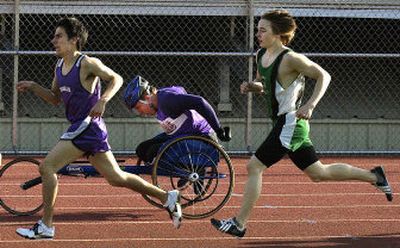 
Rogers  wheelchair athlete Cody Mace rounds the final stretch of the 800-meter race during an April 20 Greater Spokane League meet at East Valley. 
 (Liz Kishimoto / The Spokesman-Review)