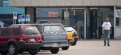 
A worker leaves the St. Thomas assembly plant in Ontario which produces the Crown Victoria and Mercury Grand Marquis. 
 (Associated Press / The Spokesman-Review)