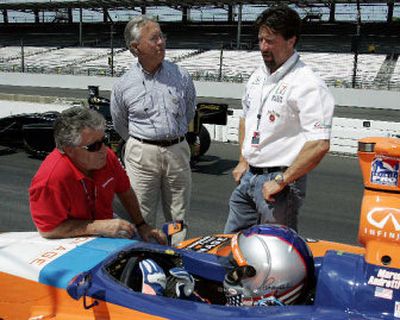 
Marco Andretti listens to advice from grandfather Mario Andretti, left, uncle Aldo Andretti, center, and father Michael Andretti. 
 (Associated Press / The Spokesman-Review)