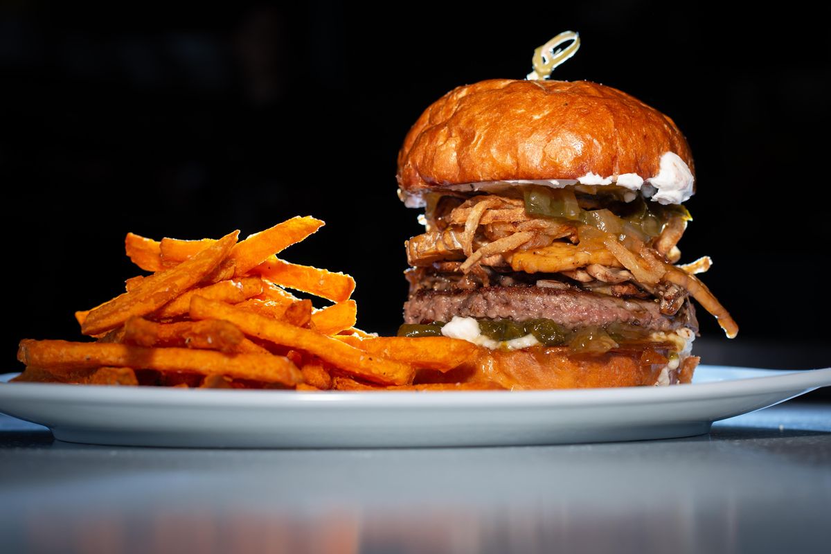 The jalapeno musroom burger goes for $15 at RÜT Bar and Kitchen and contains tempeh bacon, sauteed mushrooms, crisped onions, cream cheese and jalapeno relish on a pretzel bun, as photographed with sweet potato fries. The gastropub opened last Monday, April 8 in the South Hill District and is located at 901 W. 14th Avenue. (Libby Kamrowski / The Spokesman-Review)