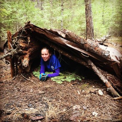 Lauren Ling takes a break in a survival shelter she made during her search and rescue qualification field exam. (Courtesy / Courtesy Lauren Ling)