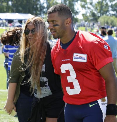 In this July 31, 2017, file photo, Seattle Seahawks quarterback Russell Wilson walks with his wife, pop singer Ciara, after NFL football training camp in Renton, Wash. (Ted S. Warren / Associated Press)