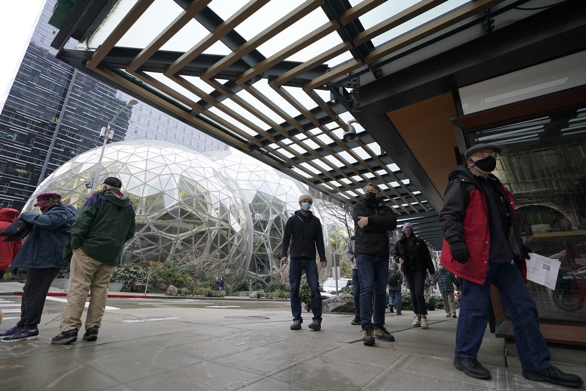 People wait Jan. 24 near the Amazon Spheres to check in to receive the first of two doses of the Pfizer vaccine for COVID-19 at a one-day vaccination clinic set up in an Amazon.com facility in Seattle operated by Virginia Mason Franciscan Health.  (Associated Press)