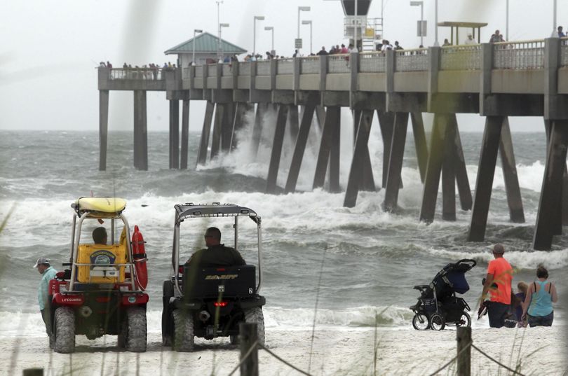 Authorities watch people near the water at the Okaloosa Pier as heavy surf brought on by Tropical Storm Cindy pounds the pier supports in Fort Walton Beach, Fla, Wednesday, June 21, 2017. (Michael Snyder/Northwest Florida Daily News via AP) ORG XMIT: FLPLA110 (Michael Snyder / AP)