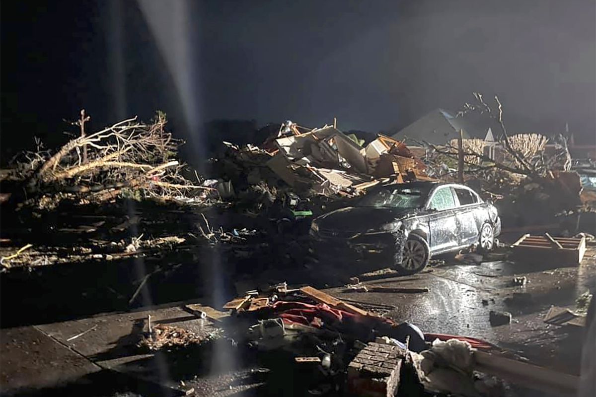 A damaged vehicle is seen among debris after a deadly tornado tore through Brunswick County, N.C., Tuesday, Feb. 16, 2021. North Carolina authorities say multiple people are dead and others were injured after a tornado ripped through Brunswick County, leaving a trail of heavy destruction.  (Emily Flax)