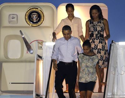 President Barack Obama arrives with first lady Michelle Obama, top, and daughters Malia, top left, and Sasha in Honolulu on Saturday. (Associated Press)