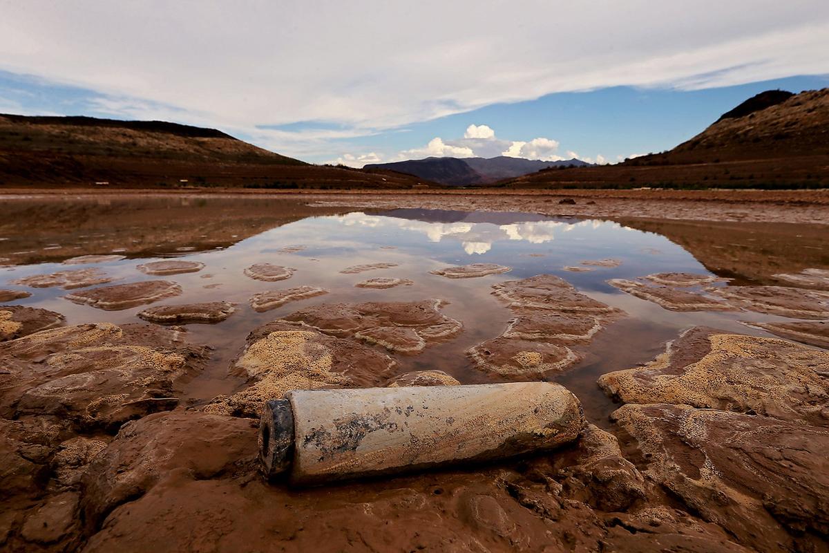 Clouds are reflected on the surface of a pool that is separated from the main body of water in Lake Mead in August 2022. The reservoir, one of the largest in the nation, is filled by the Colorado River.  (Tribune News Service)