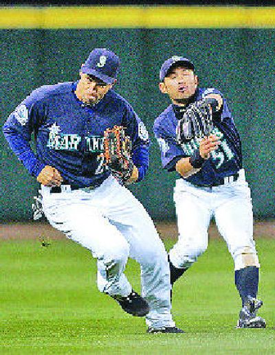 
Seattle's Raul Ibanez, left, and center fielder Ichiro Suzuki nearly collide. 
 (Associated Press / The Spokesman-Review)