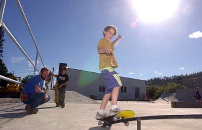 
Eric Wagoner, 11, tries out a rail in the new skate park in Rathdrum on Thursday while his father, Mike Wagoner, and brother Joey, 13, look on. The new Rathdrum skate park will be dedicated Saturday as part of Rathdrum Days, the town's annual festival. 
 (Jesse Tinsley / The Spokesman-Review)