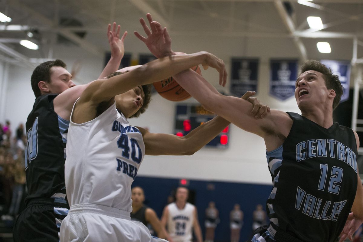 Gonzaga Prep forward Anton Watson (40) competes for a rebound with Central Valley guard Ryan Rehkow, left, and  guard Cameron Tucker  during the first half. (Colin Mulvany / The Spokesman-Review)