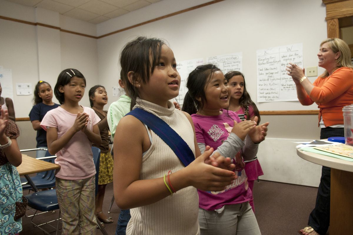 Ehlawlah, center, a refugee from Myanmar, chants with other new English speakers  during English Language Camp at Gonzaga University last month.  (Jesse Tinsley)