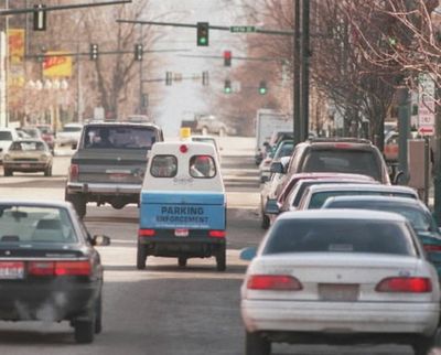 In this SR file photo, a Diamond Parking employee marks tires in downtown Coeur d'Alene. (Shawn Jacobson/SR file photo)