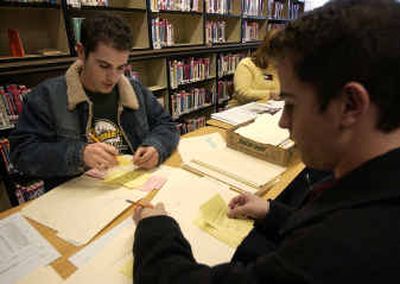 
University High seniors Jeffrey, left, and Justin Kemp count presidential votes in the library at Horizon Middle School on Monday in Spokane Valley. The Kemp brothers, both 18, are planning on voting in today's election. 
 (Liz Kishimoto / The Spokesman-Review)