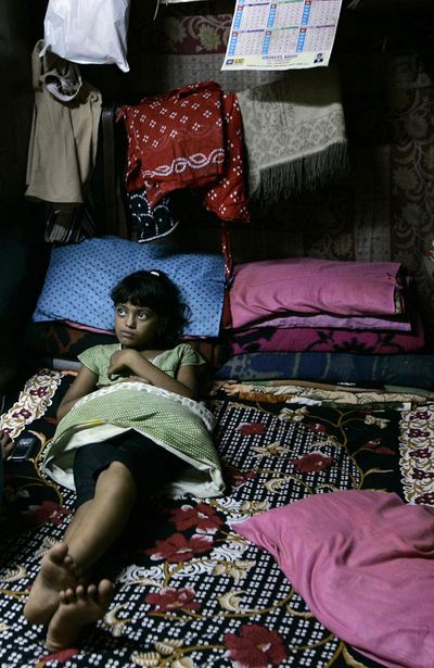 Rubina Ali rests at the home of a relative at a slum area in Mumbai, India, on Saturday.  Rubina, 9, fell sick days after city authorities demolished the shanty where she lived, family members said.  (Associated Press / The Spokesman-Review)