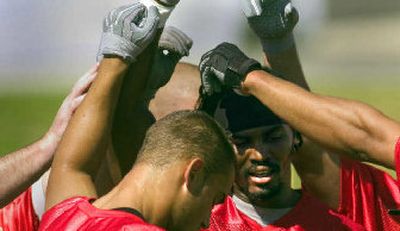 
Muhammad Shamsid-Deen, facing camera, breaks the huddle with other defensive backs on opening day of EWU's camp on Thursday. 
 (Christopher Anderson/ / The Spokesman-Review)
