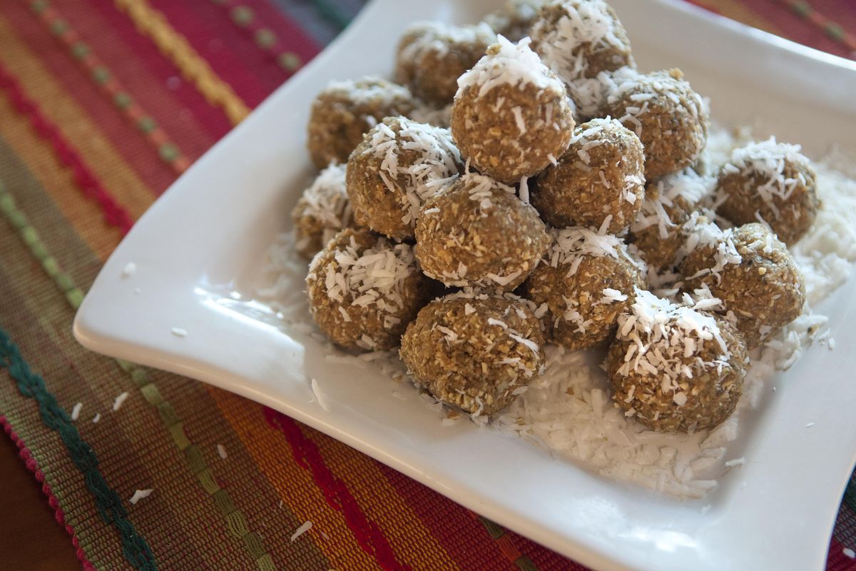 Made with ground pumpkin seeds, these slightly sweet, coconut-rolled balls provide a healthy snack or dessert. (Adriana Janovich / The Spokesman-Review)