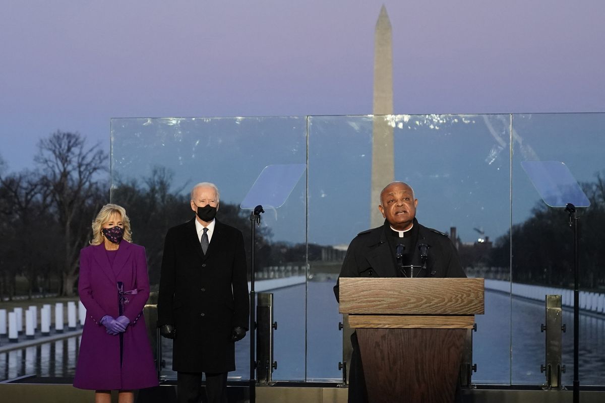 Joe Biden, then president-elect, and his wife, Jill, listen as Cardinal Wilton Gregory, Archbishop of Washington, delivers the invocation during a COVID-19 memorial Jan. 19 at the Lincoln Memorial Reflecting Pool in Washington.  (Alex Brandon)