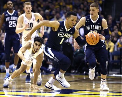 Villanova’s Jalen Brunson, center, steals the ball from Marquette’s Markus Howard on Sunday in Milwaukee. (Tom Lynn / Associated Press)