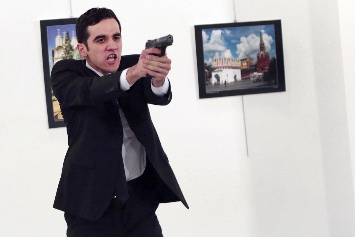 An unnamed gunman gestures after shooting the Russian Ambassador to Turkey, Andrei Karlov, at a photo gallery in Ankara, Turkey, on Monday. (Burhan Ozbilici / Associated Press)