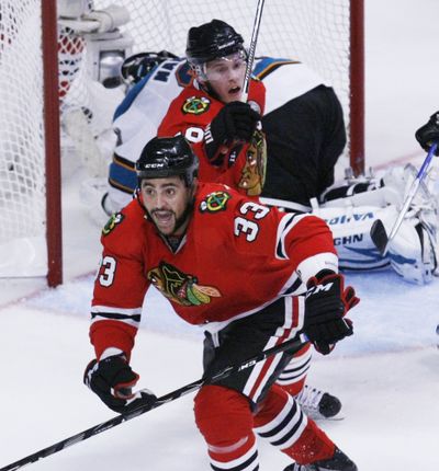 Chicago’s Dustin Byfuglien celebrates after scoring the go-ahead goal in the third period. (Associated Press)